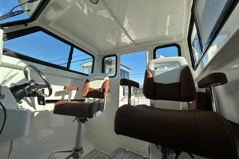  Yacht Photos Pics Interior of 2026 Parker 227 Explorer boat with modern seating and steering wheel.
