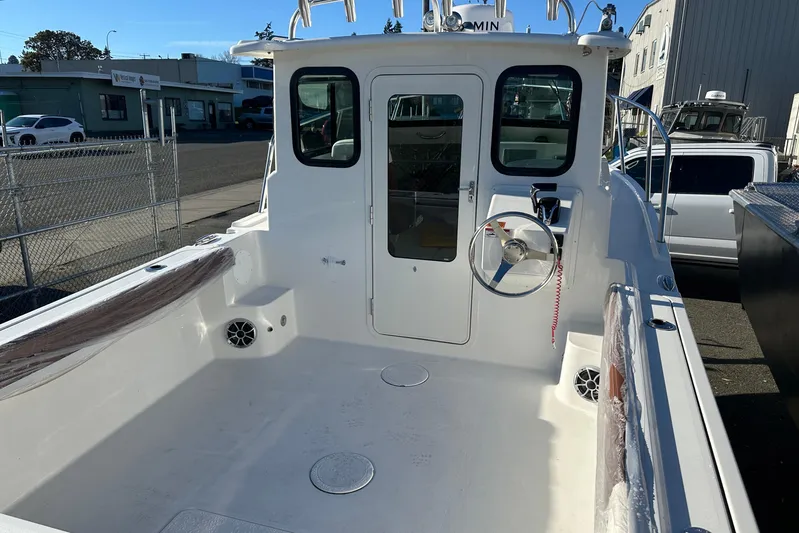  Yacht Photos Pics 2026 Parker 227 Explorer boat interior with steering wheel and seating area.