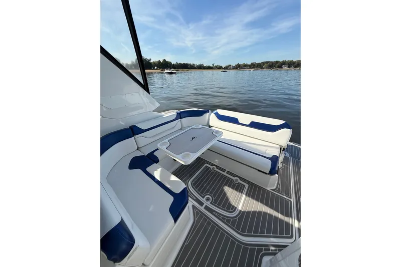 Wanderlust Yacht Photos Pics 2015 Monterey 355 Sport Yacht interior with blue and white seating, overlooking serene water.