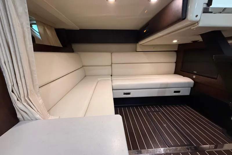 Wanderlust Yacht Photos Pics Luxurious interior of 2015 Monterey 355 Sport Yacht with cream leather seating and wood flooring.