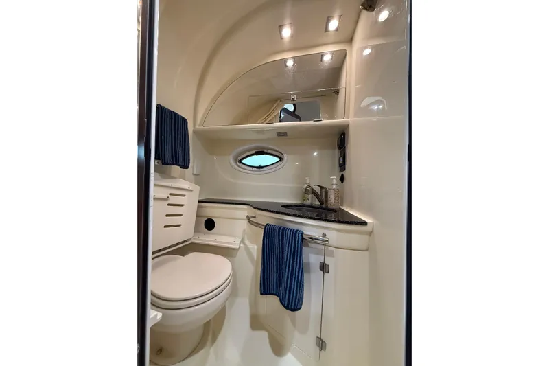 Wanderlust Yacht Photos Pics 2015 Monterey 355 Sport Yacht bathroom with toilet, sink, mirror, and blue towels.