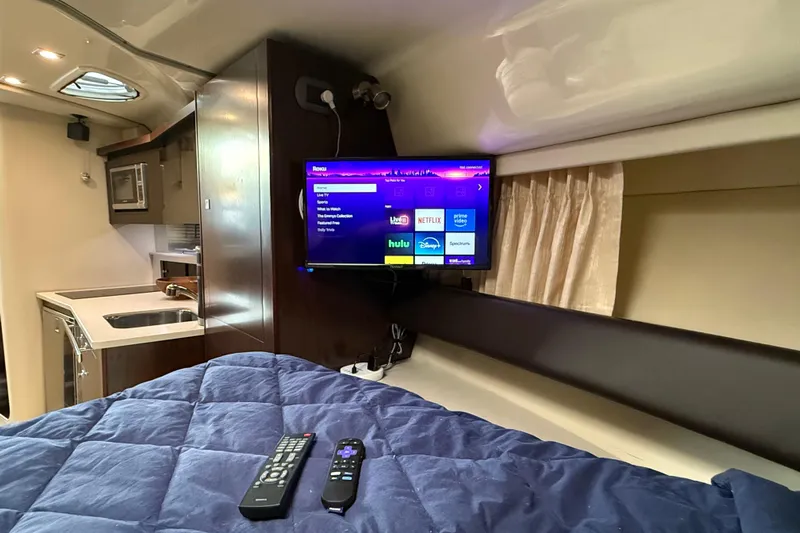 Wanderlust Yacht Photos Pics Interior of 2015 Monterey 355 Sport Yacht with TV, bed, and kitchenette.