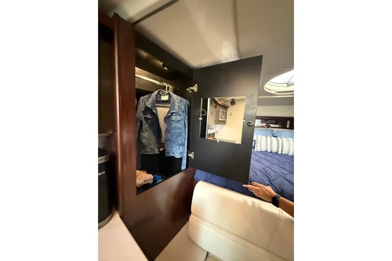 Wanderlust Yacht Photos Pics Interior of 2015 Monterey 355 Sport Yacht with open closet and denim jacket.