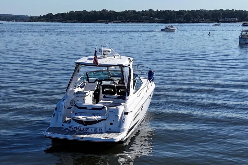 Wanderlust Yacht Photos Pics 2015 Monterey 355 Sport Yacht on calm water, rear view with American flag.