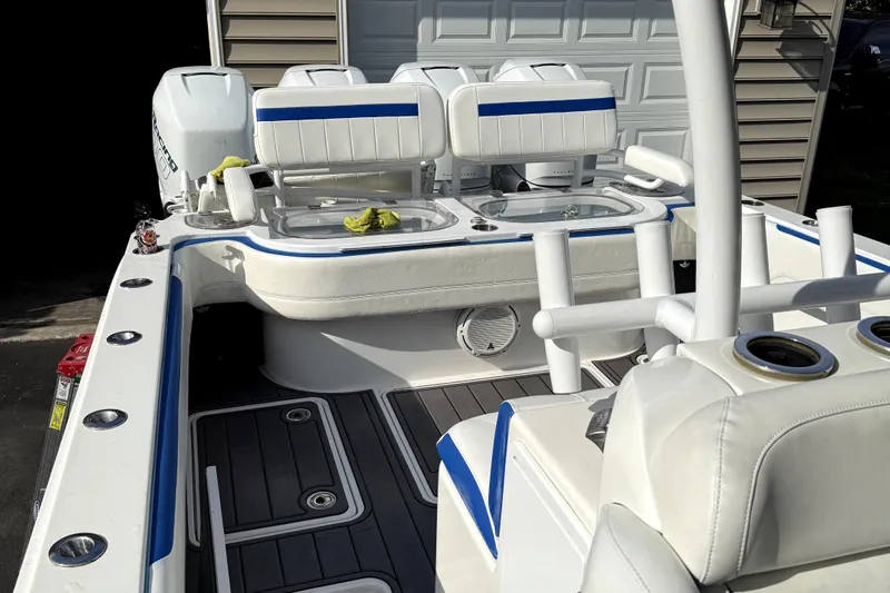  Yacht Photos Pics 2017 Nor-Tech 392 Superfish boat interior with white and blue seating, fishing rod holders, and storage.