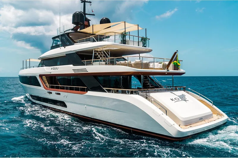 Koju Yacht Photos Pics Luxurious 2022 Benetti Motopanfilo yacht cruising on open sea under clear skies.
