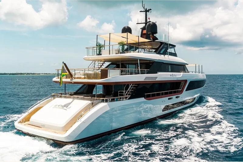 Koju Yacht Photos Pics Luxury 2022 Benetti Motopanfilo yacht cruising on open sea under clear skies.