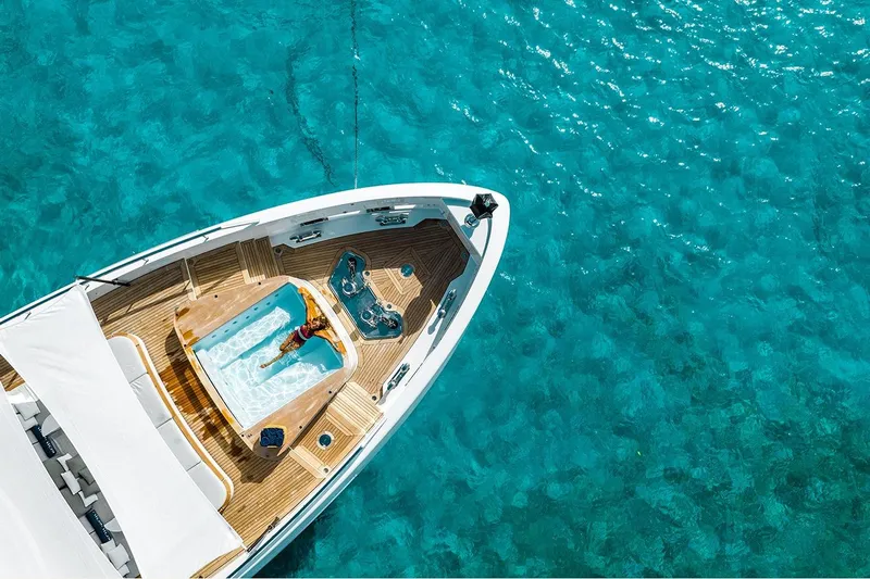 Koju Yacht Photos Pics Aerial view of 2022 Benetti Motopanfilo yacht with jacuzzi on turquoise water.
