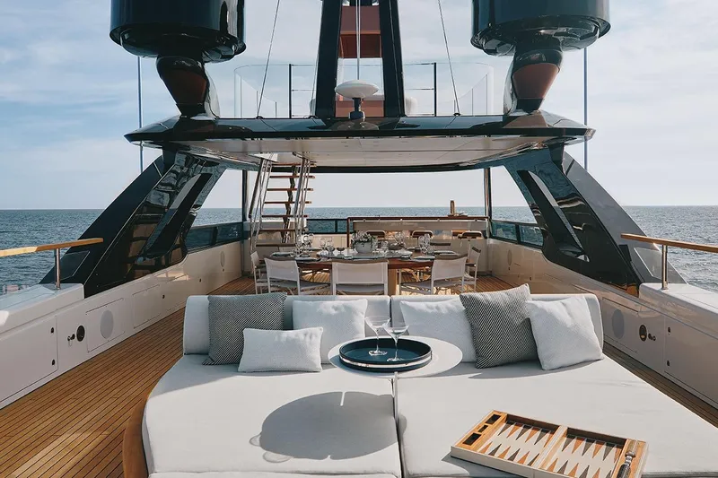 Koju Yacht Photos Pics Luxurious 2022 Benetti Motopanfilo yacht deck with elegant seating and dining area.
