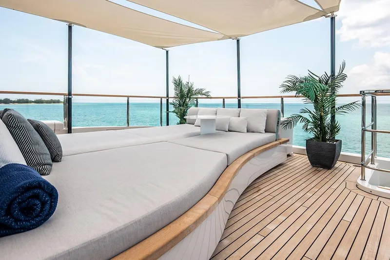 Koju Yacht Photos Pics Luxurious 2022 Benetti Motopanfilo yacht deck with sun loungers and ocean view.