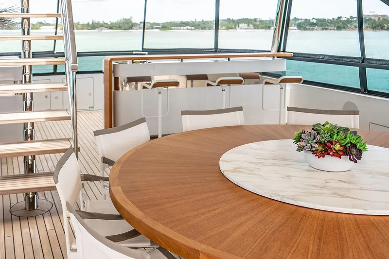 Koju Yacht Photos Pics Luxurious 2022 Benetti Motopanfilo yacht interior with elegant dining area and ocean view.