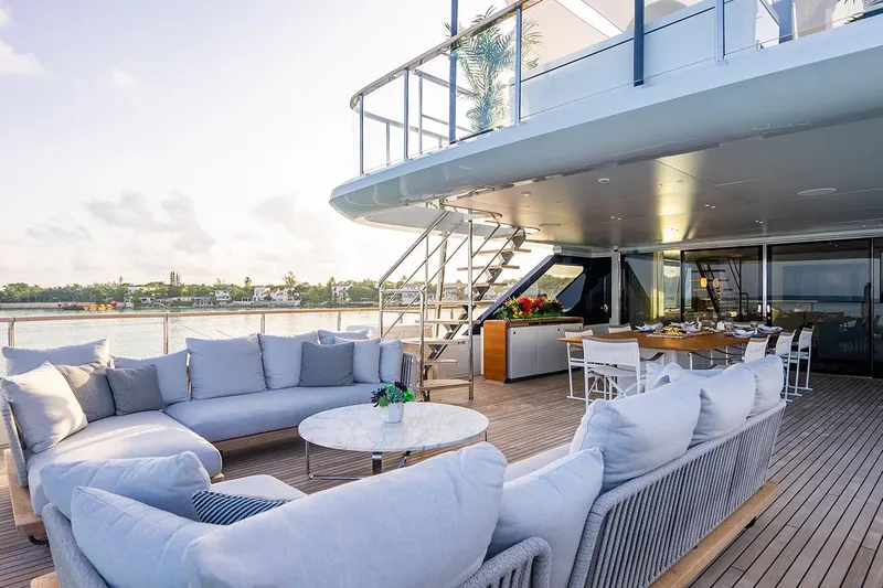 Koju Yacht Photos Pics Luxurious 2022 Benetti Motopanfilo yacht deck with elegant seating and dining area.