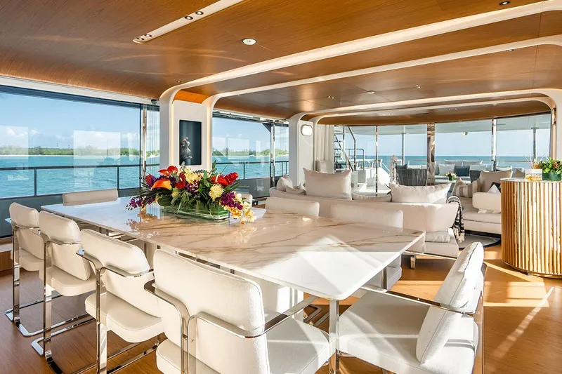 Koju Yacht Photos Pics Luxurious interior of 2022 Benetti Motopanfilo yacht with elegant dining area and ocean view.