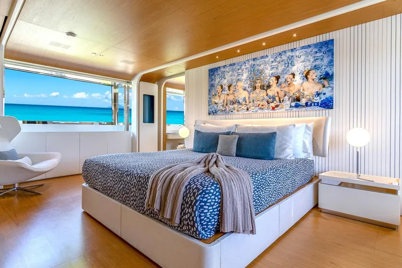 Koju Yacht Photos Pics Luxurious bedroom on 2022 Benetti Motopanfilo yacht with ocean view and elegant decor.
