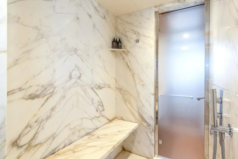 Koju Yacht Photos Pics Luxurious marble bathroom in 2022 Benetti Motopanfilo yacht with frosted glass door.