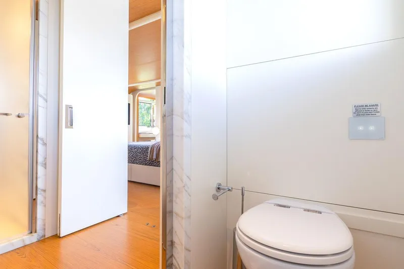 Koju Yacht Photos Pics Luxurious Benetti Motopanfilo 2022 yacht bathroom with modern design and wooden flooring.