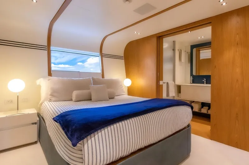 Koju Yacht Photos Pics Luxurious bedroom interior on 2022 Benetti Motopanfilo yacht, featuring modern design and cozy ambiance.
