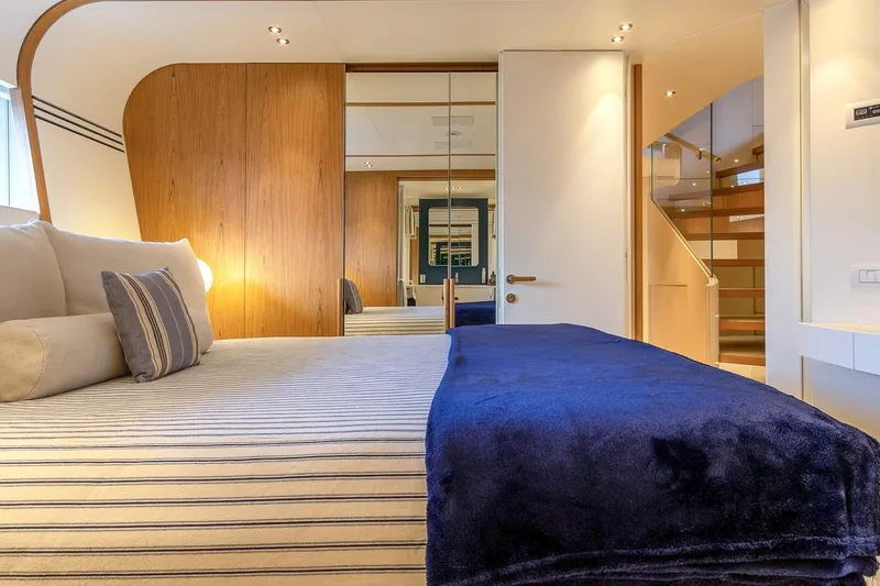 Koju Yacht Photos Pics Luxurious bedroom interior on 2022 Benetti Motopanfilo yacht with modern design and cozy bedding.