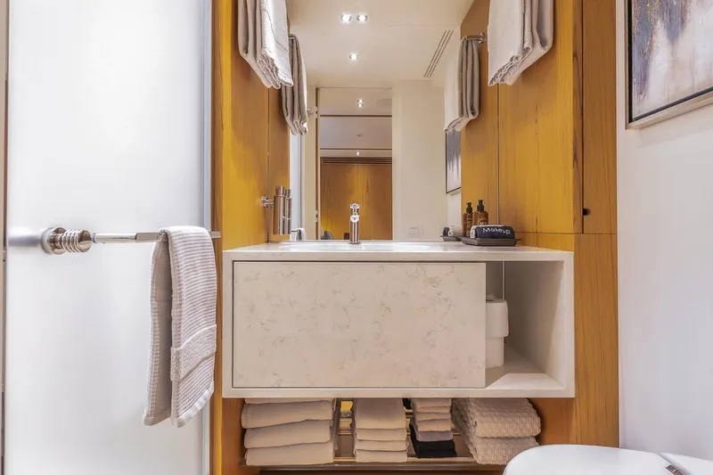 Koju Yacht Photos Pics Luxurious bathroom interior on 2022 Benetti Motopanfilo yacht, featuring modern sink and elegant wood accents.