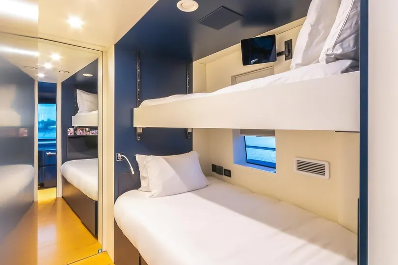 Koju Yacht Photos Pics Luxurious 2022 Benetti Motopanfilo yacht cabin with modern bunk beds and sleek design.