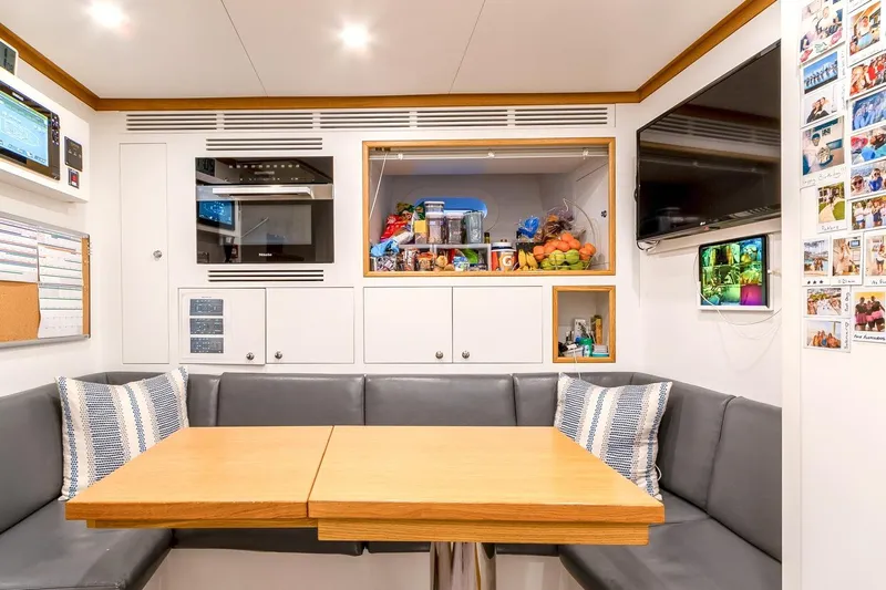 Koju Yacht Photos Pics Luxurious 2022 Benetti Motopanfilo yacht interior with cozy dining area and modern amenities.