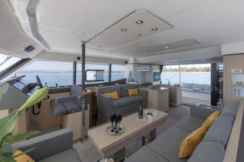 Mona Lisa Yacht Photos Pics Luxurious interior of 2024 Fountaine Pajot MY.6 yacht with modern furnishings and ocean view.