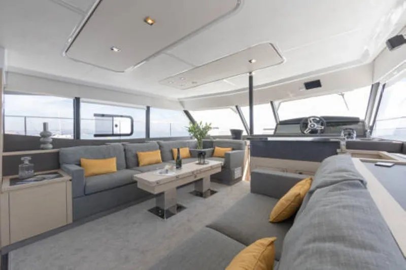 Mona Lisa Yacht Photos Pics Luxurious interior of 2024 Fountaine Pajot MY.6 yacht with modern seating and decor.