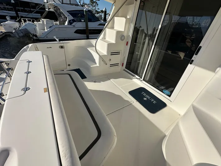  Yacht Photos Pics 2005 Sea Ray 420 Sedan Bridge yacht deck with seating and stairs, docked at marina.