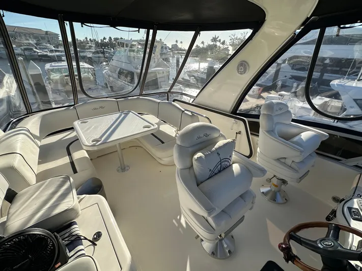  Yacht Photos Pics 2005 Sea Ray 420 Sedan Bridge interior with seating and helm, showcasing luxury yacht design.