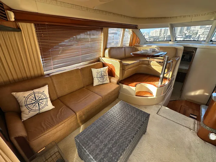  Yacht Photos Pics Interior of 2005 Sea Ray 420 Sedan Bridge with cozy seating and nautical decor.