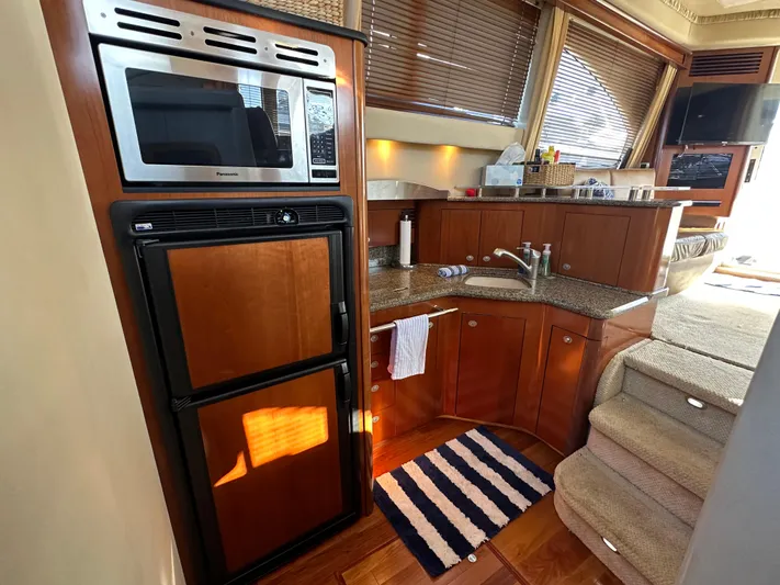  Yacht Photos Pics Interior of 2005 Sea Ray 420 Sedan Bridge yacht with kitchen and stairs.