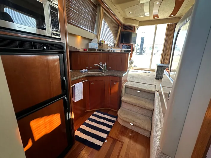  Yacht Photos Pics Interior of 2005 Sea Ray 420 Sedan Bridge yacht with kitchen and stairs.