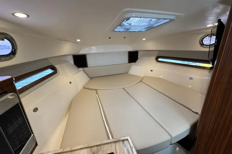  Yacht Photos Pics 2018 Pursuit OS 325 Offshore cabin interior with modern design and comfortable seating.