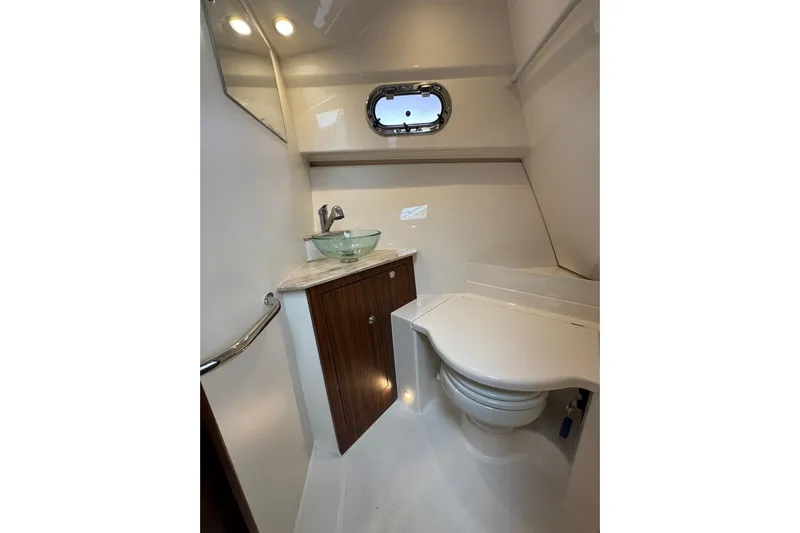  Yacht Photos Pics 2018 Pursuit OS 325 Offshore boat bathroom with modern sink and compact toilet.