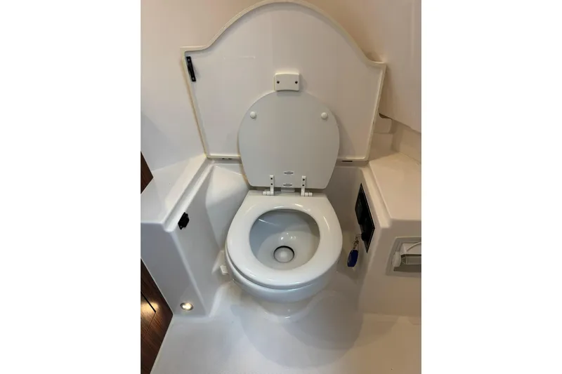  Yacht Photos Pics 2018 Pursuit OS 325 Offshore boat toilet, white interior, compact marine design.