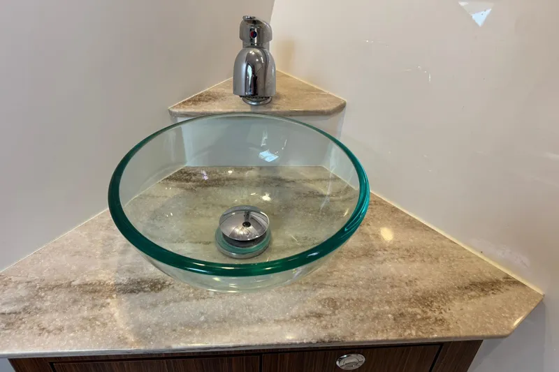  Yacht Photos Pics Glass sink with chrome faucet on marble countertop in 2018 Pursuit OS 325 Offshore.