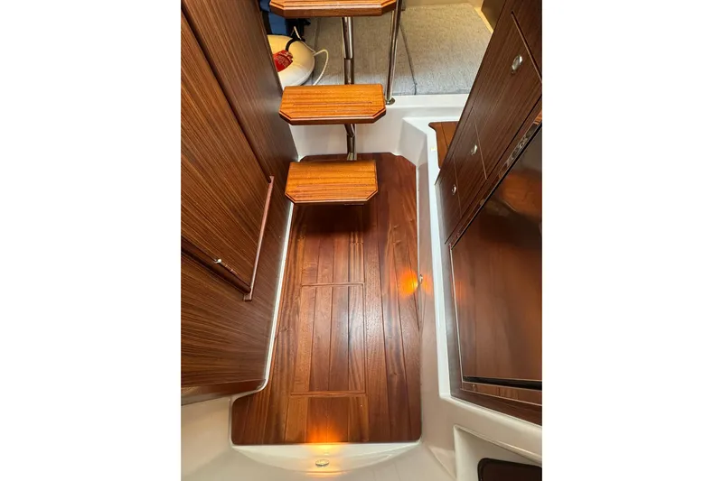  Yacht Photos Pics 2018 Pursuit OS 325 Offshore interior with wooden steps and flooring.