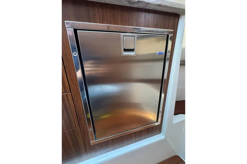  Yacht Photos Pics Stainless steel door on 2018 Pursuit OS 325 Offshore boat, featuring wood paneling.