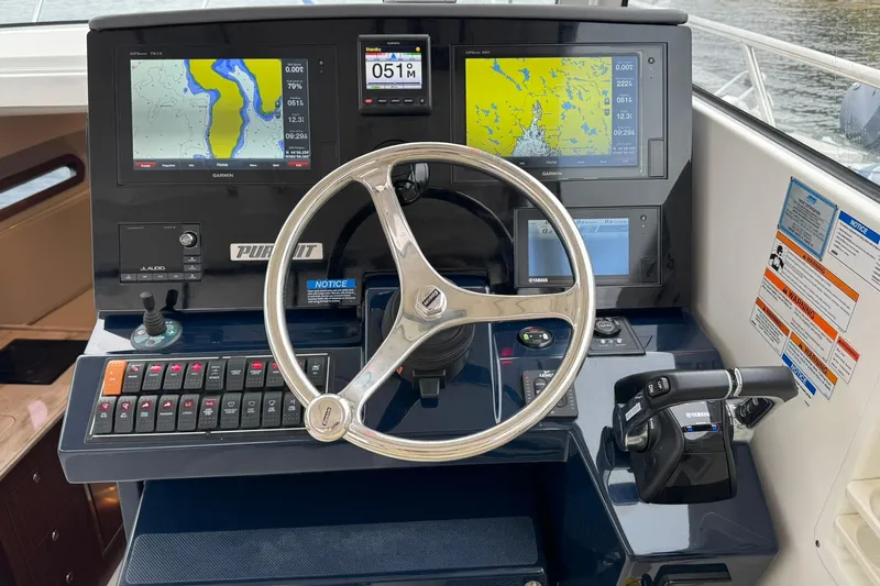  Yacht Photos Pics 2018 Pursuit OS 325 Offshore helm with Garmin navigation displays and Yamaha controls.