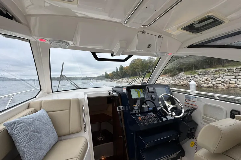  Yacht Photos Pics Interior view of 2018 Pursuit OS 325 Offshore boat with helm and seating area.