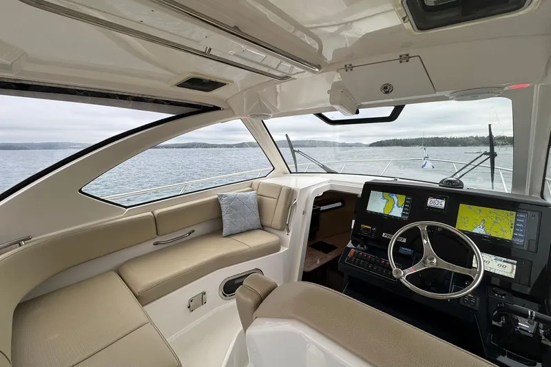  Yacht Photos Pics Interior of 2018 Pursuit OS 325 Offshore boat with navigation system and seating.