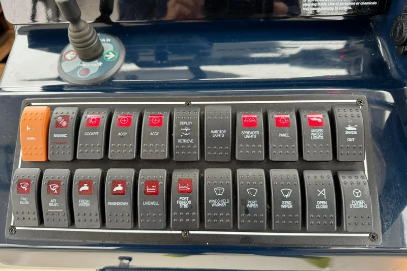  Yacht Photos Pics Control panel of a 2018 Pursuit OS 325 Offshore boat with labeled switches.