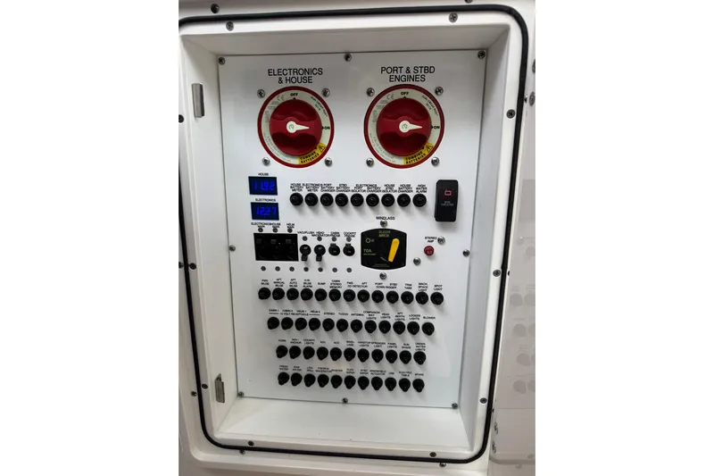  Yacht Photos Pics Electrical control panel of 2018 Pursuit OS 325 Offshore boat, featuring switches and gauges.