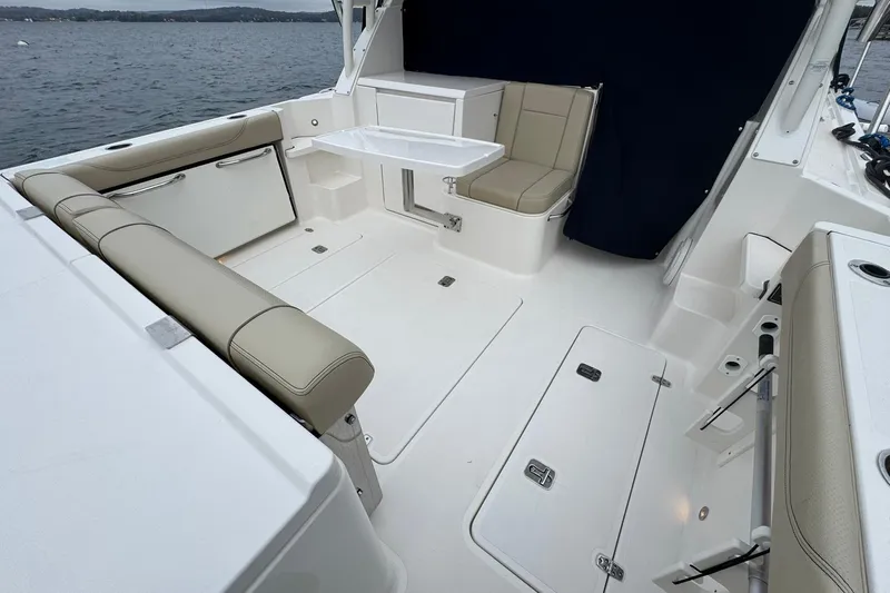  Yacht Photos Pics 2018 Pursuit OS 325 Offshore boat interior with beige seating and white deck.