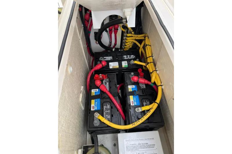  Yacht Photos Pics Battery compartment of 2018 Pursuit OS 325 Offshore boat with cables and connections.
