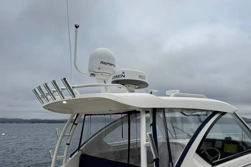  Yacht Photos Pics 2018 Pursuit OS 325 Offshore boat with radar equipment on a cloudy day.