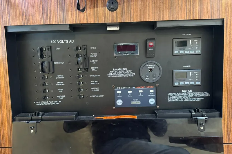  Yacht Photos Pics Electrical control panel of a 2018 Pursuit OS 325 Offshore boat, featuring various switches and displays.