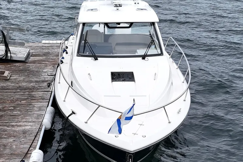  Yacht Photos Pics 2018 Pursuit OS 325 Offshore boat docked on calm water.