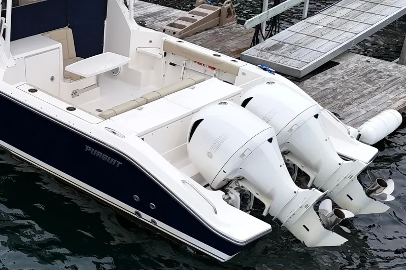  Yacht Photos Pics 2018 Pursuit OS 325 Offshore boat with dual outboard engines docked at marina.