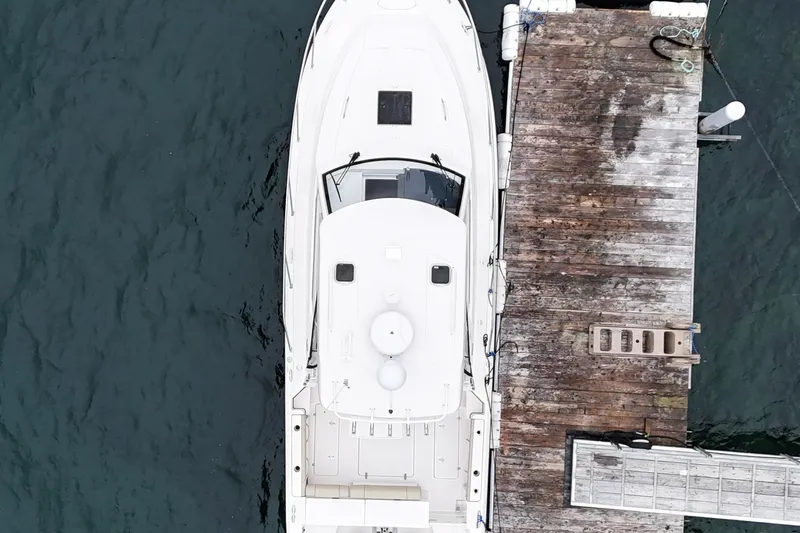  Yacht Photos Pics Overhead view of 2018 Pursuit OS 325 Offshore yacht docked at a wooden pier.